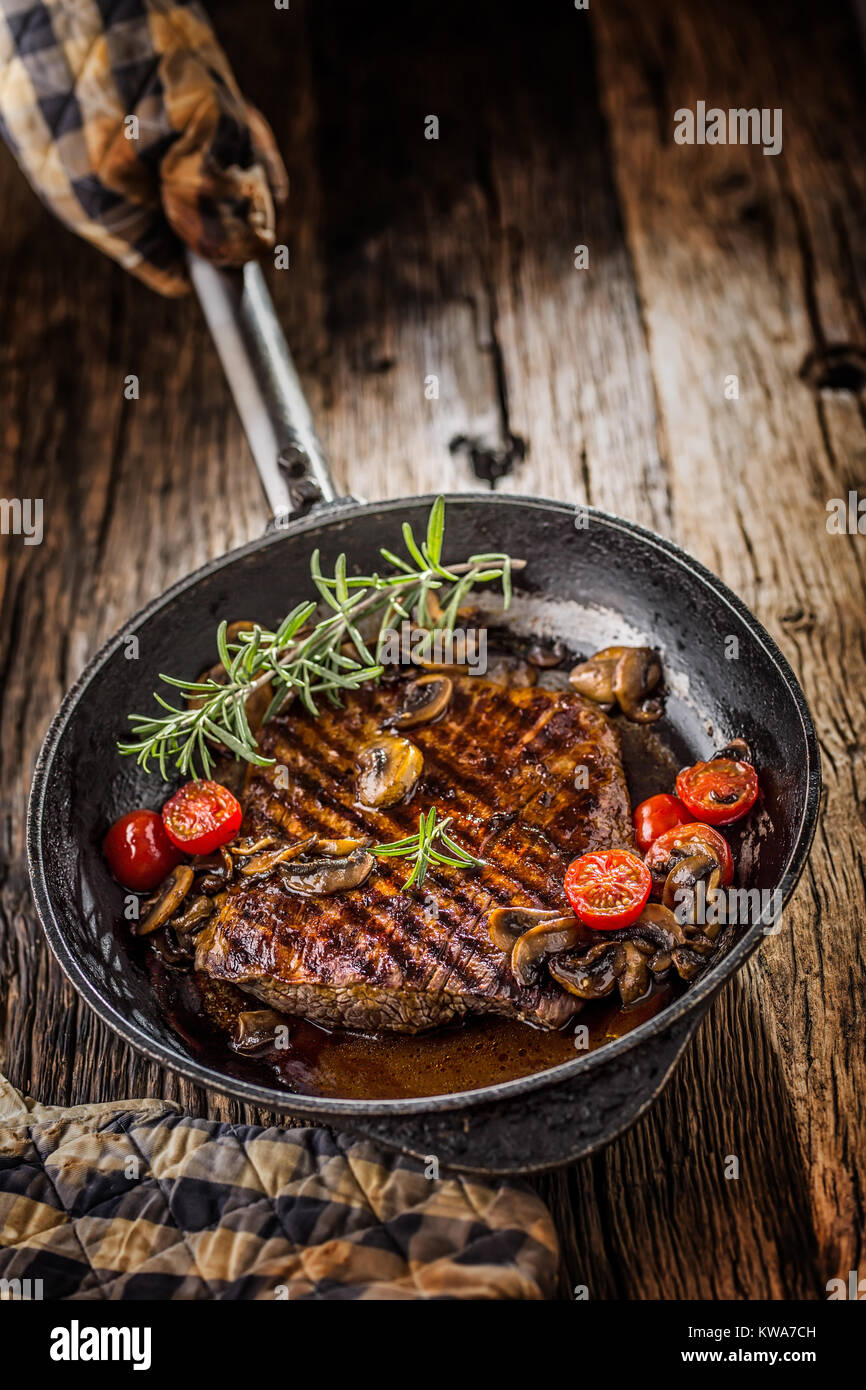 Beef steak. Grill beef flank steak with rosemary musrooms and tomatoes