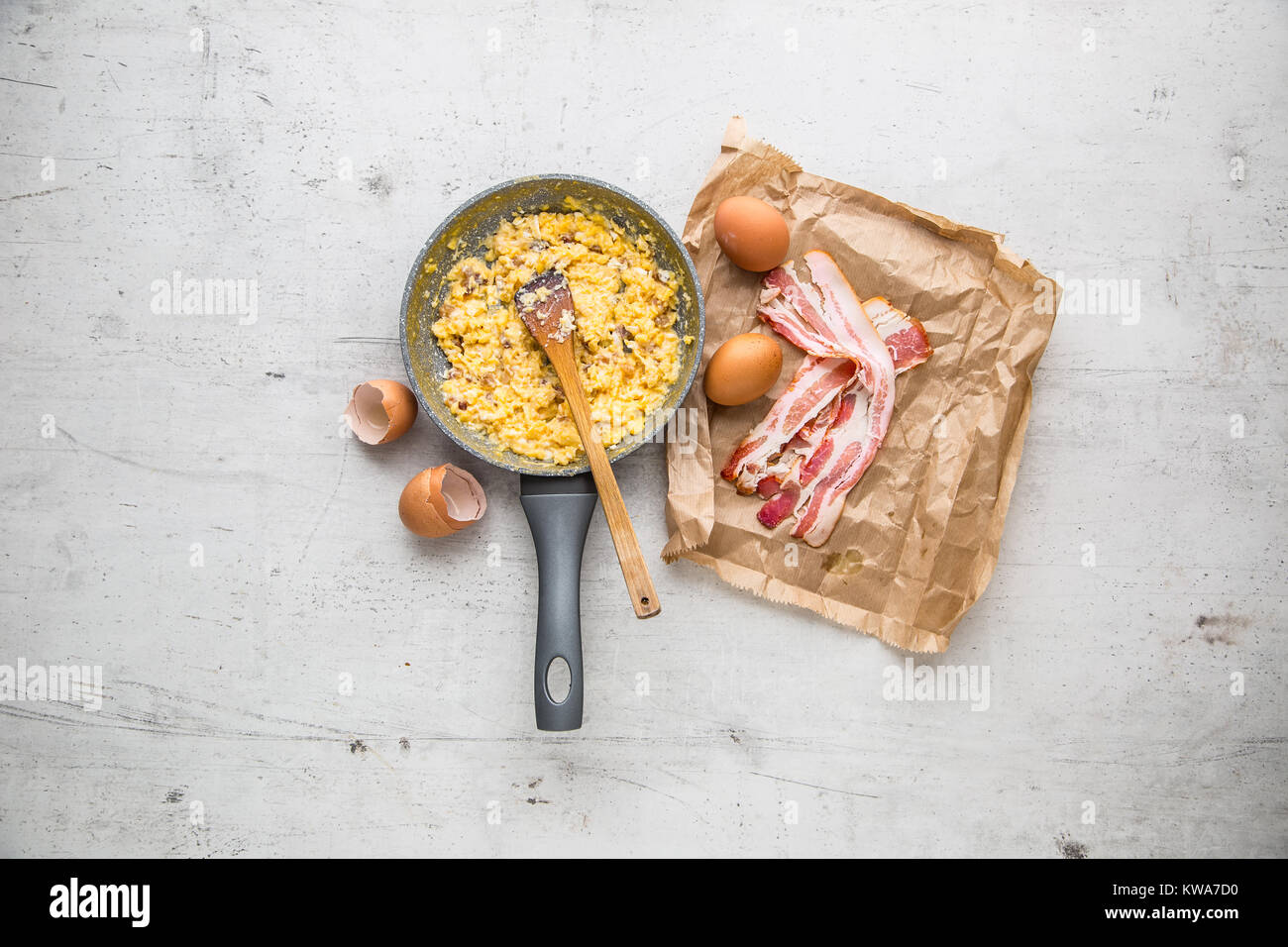 Ham and eggs. Scrambled eggs with bacon in ceramic pan Stock Photo Alamy