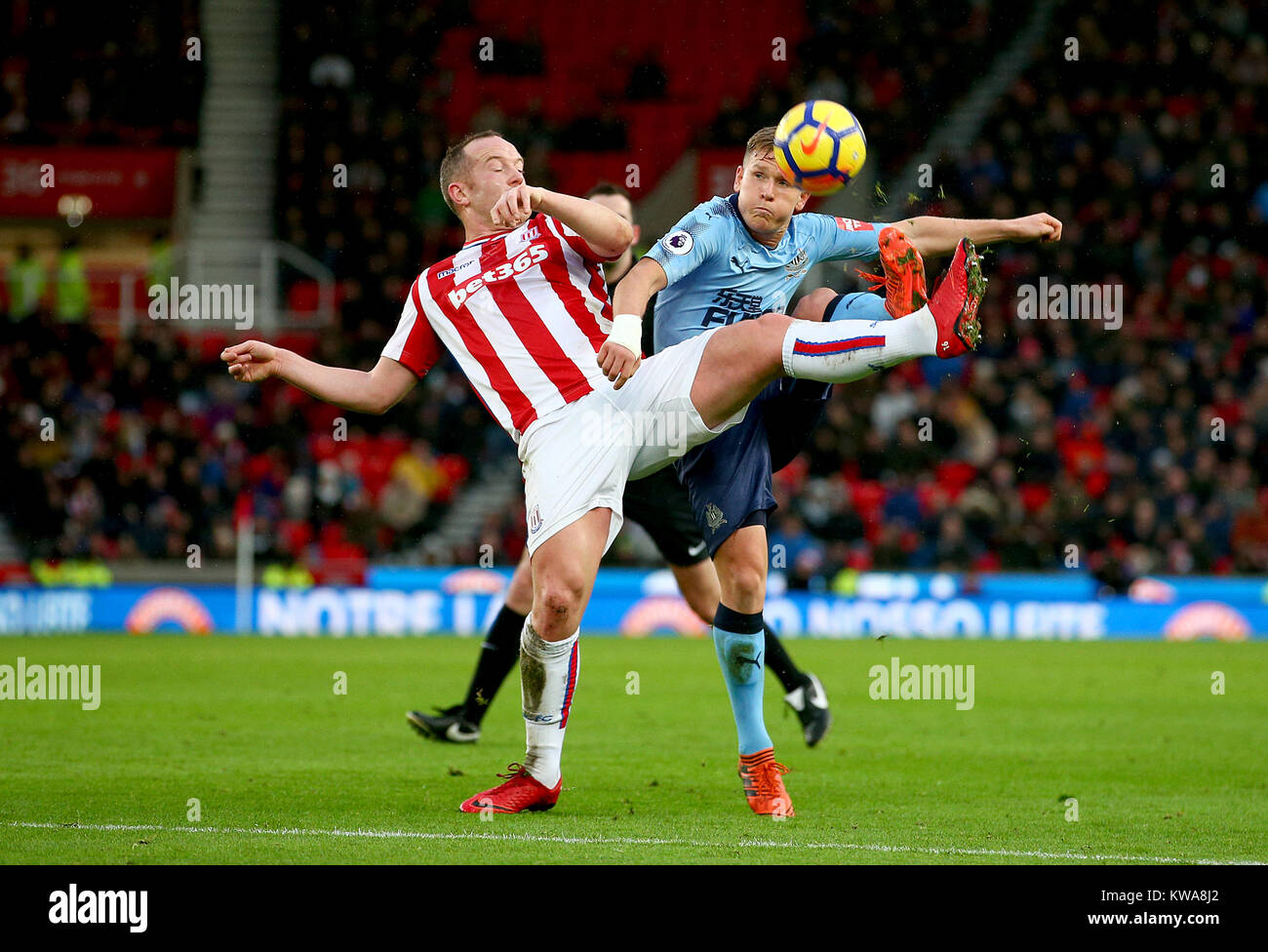 Stoke City's Charlie Adam (left) and Newcastle United's Matt Ritchie ...