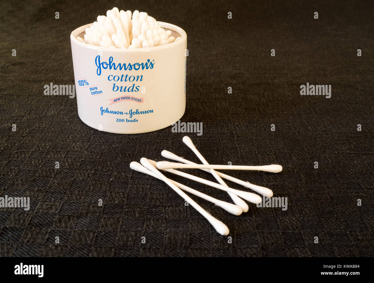A box of new paper stemmed cotton buds against black backgound Stock Photo