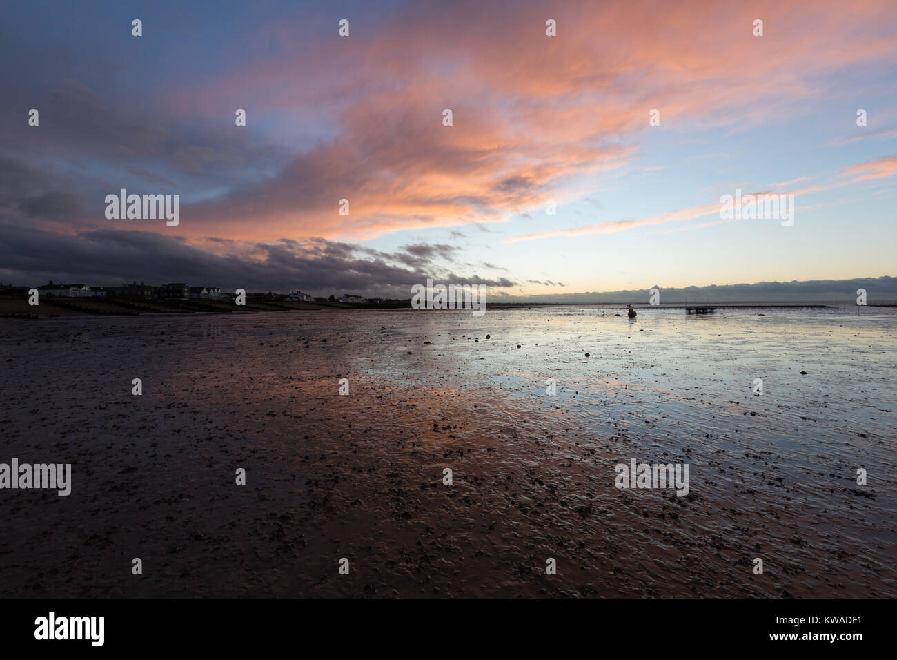 Whitstable, Kent. 1st Jan, 2018. UK Weather. Pink clouds over Whitstable Kent UK beach during New Years Day at sunset 1 January 2018 Credit: Sue Holness/Alamy Live News Stock Photo