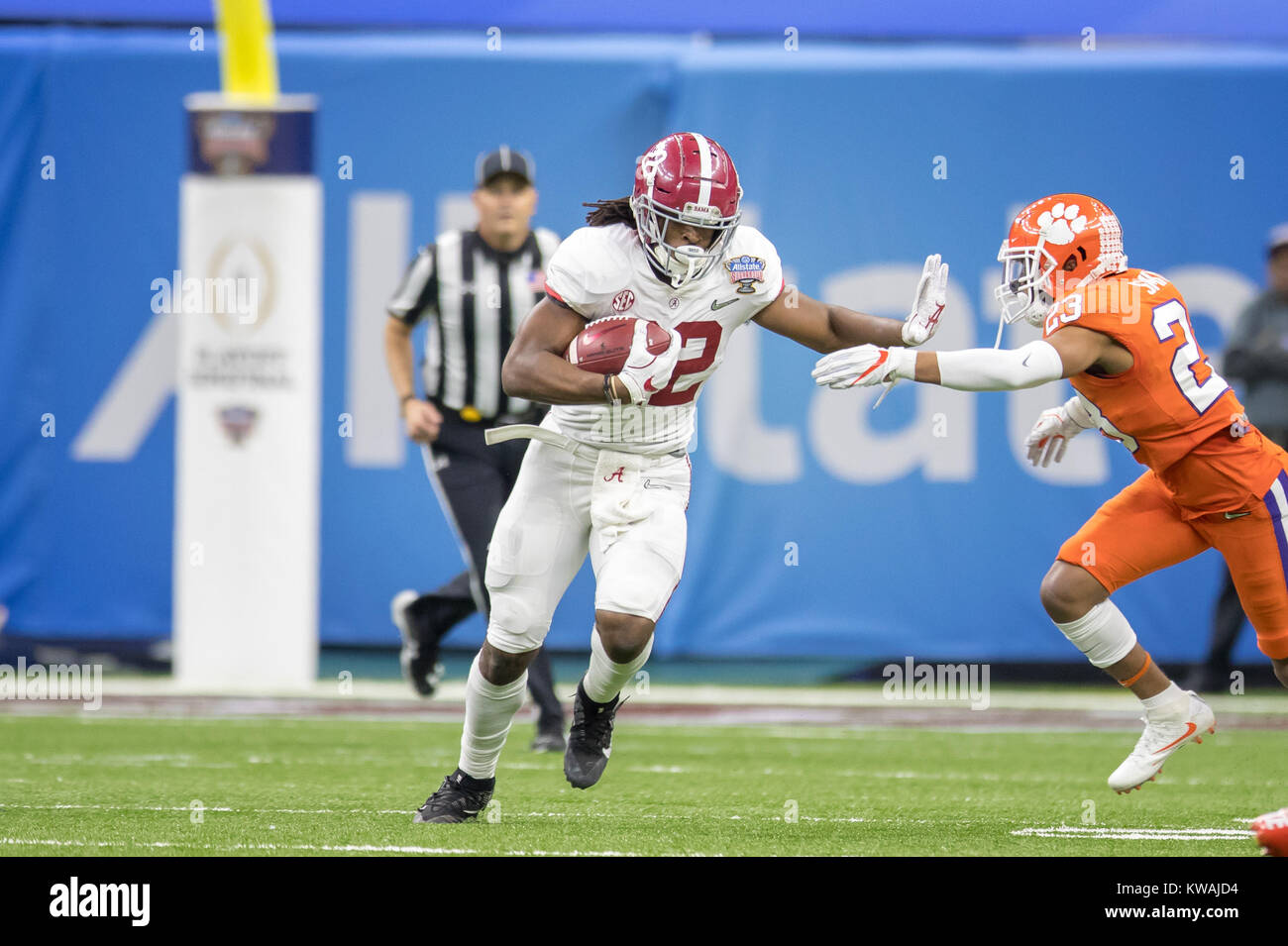New Orleans, LA, USA. 1st Jan, 2018. Alabama RB Najee Harris #22 about to stiff arm a Clemson defender during the Allstate Sugar Bowl football game between the Clemson Tigers and the Alabama Crimson Tide at the Mercedes-Benz Supedome in New Orleans, LA. Kyle Okita/CSM/Alamy Live News Stock Photo