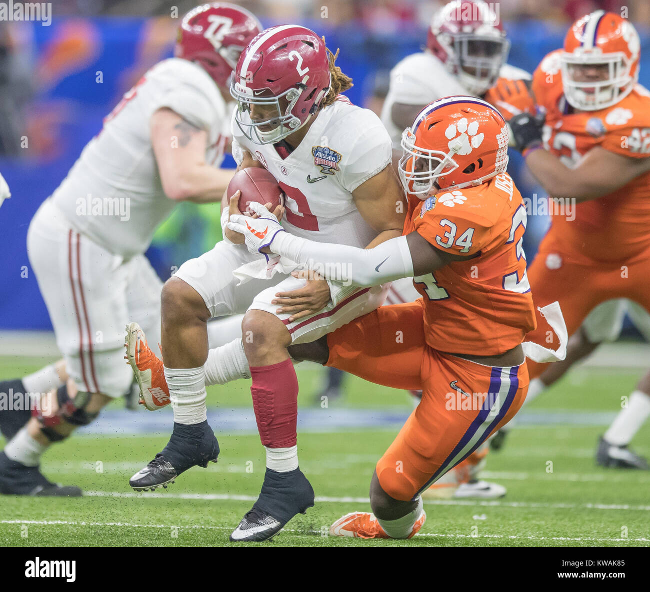 New Orleans, LA, USA. 1st Jan, 2018. Alabama's Jalen Hurts #2 is tackled by Clemson's Kendall Joseph #34 during the Allstate Sugar Bowl football game between the Clemson Tigers and the Alabama Crimson Tide at the Mercedes-Benz Supedome in New Orleans, LA. Kyle Okita/CSM/Alamy Live News Stock Photo