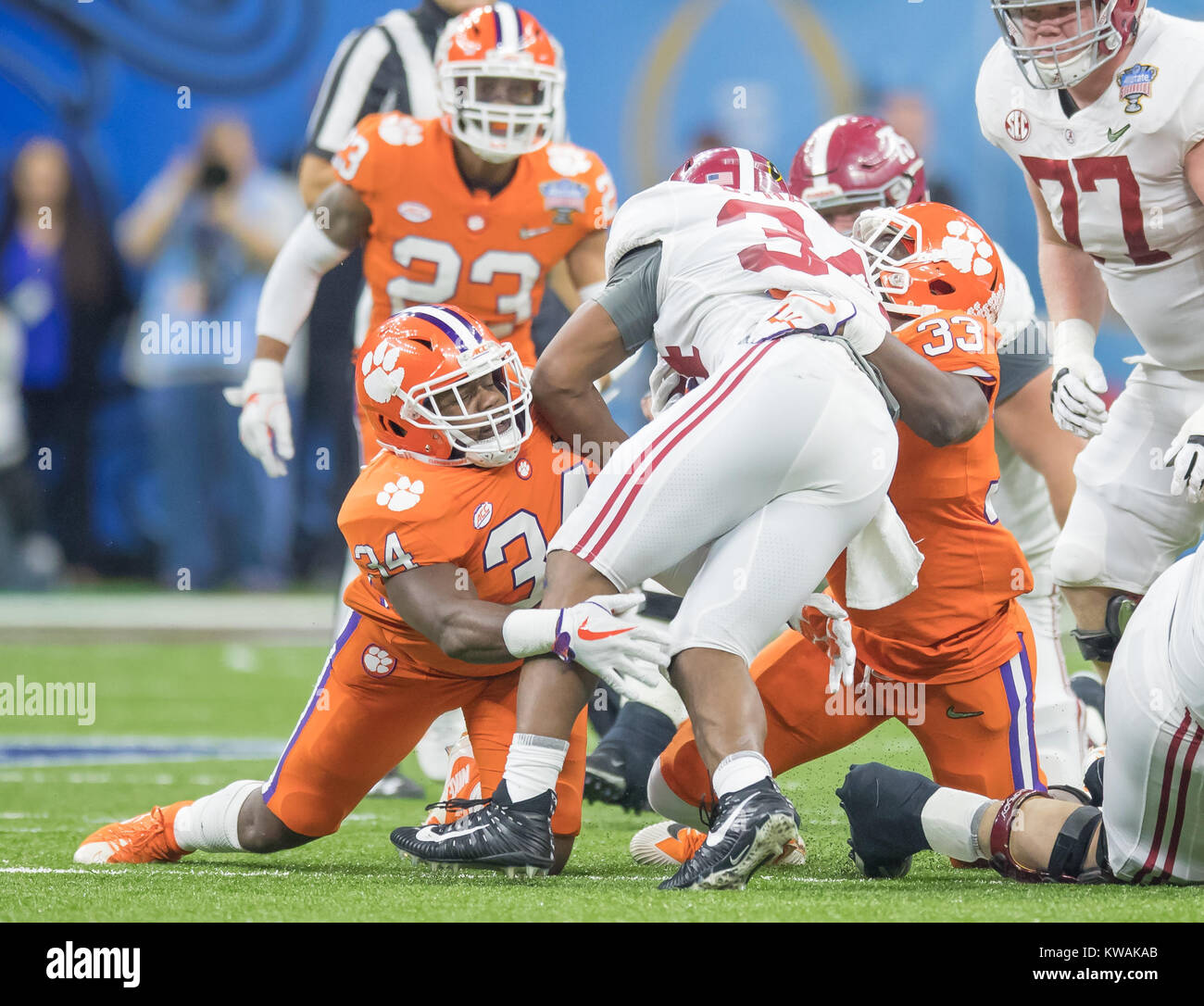 New Orleans, LA, USA. 1st Jan, 2018. Clemson defenders Kendall Joseph #34 and J.D Davis #33 team up to tackle Alabama RB Damien Harris #34 during the Allstate Sugar Bowl football game between the Clemson Tigers and the Alabama Crimson Tide at the Mercedes-Benz Supedome in New Orleans, LA. Kyle Okita/CSM/Alamy Live News Stock Photo