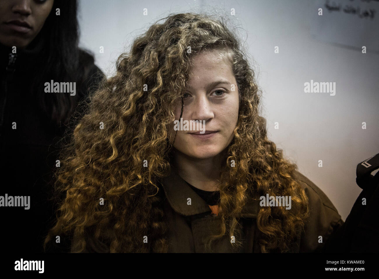 Baituniya, Palestinian Territories. 1st Jan, 2018. Ahed Tamimi is lead into the court room of the Ofer Military Prison in Baituniya, Palestinian Territories, 1 January 2018. The young Palestinian had hit an Israeli soldier in the face in front of a camera mid December 2017. Credit: Ilia Yefimovich/dpa/Alamy Live News Stock Photo