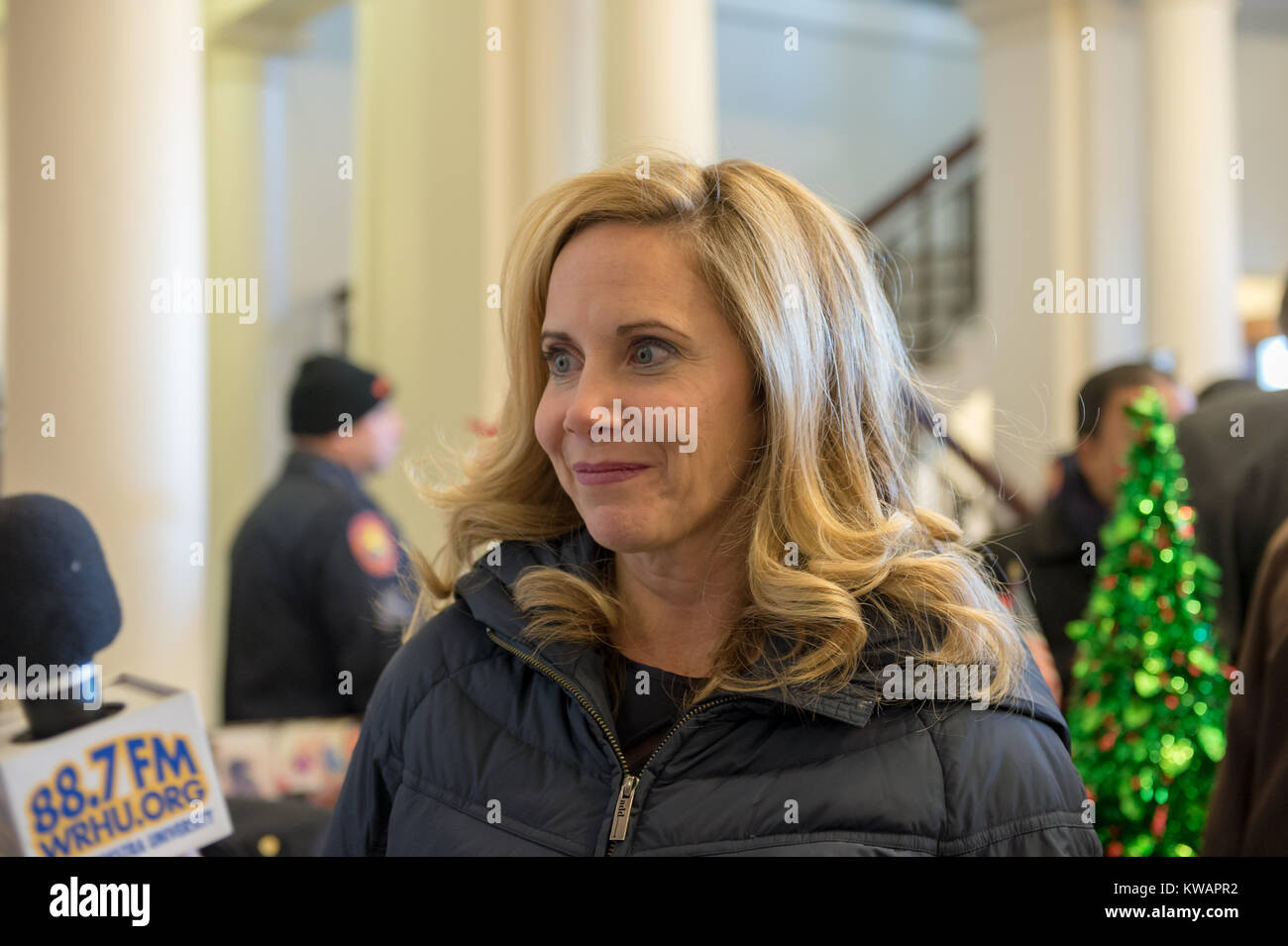 Mineola, New York, USA. January 1, 2018. Town of Hempstead Supervisor LAURA GILLEN, a Democrat, is interviewed by a reporter for Hofstra University's WRHU radio station, after historic swearing-In of Laura Curran as Nassau County Executive. They were in the Theodore Roosevelt Executive & Legislative Building, which the Curran swearing-in was held in front of the entrance outdoors. Gillen's swearing in was held that morning at Hofstra University. Stock Photo