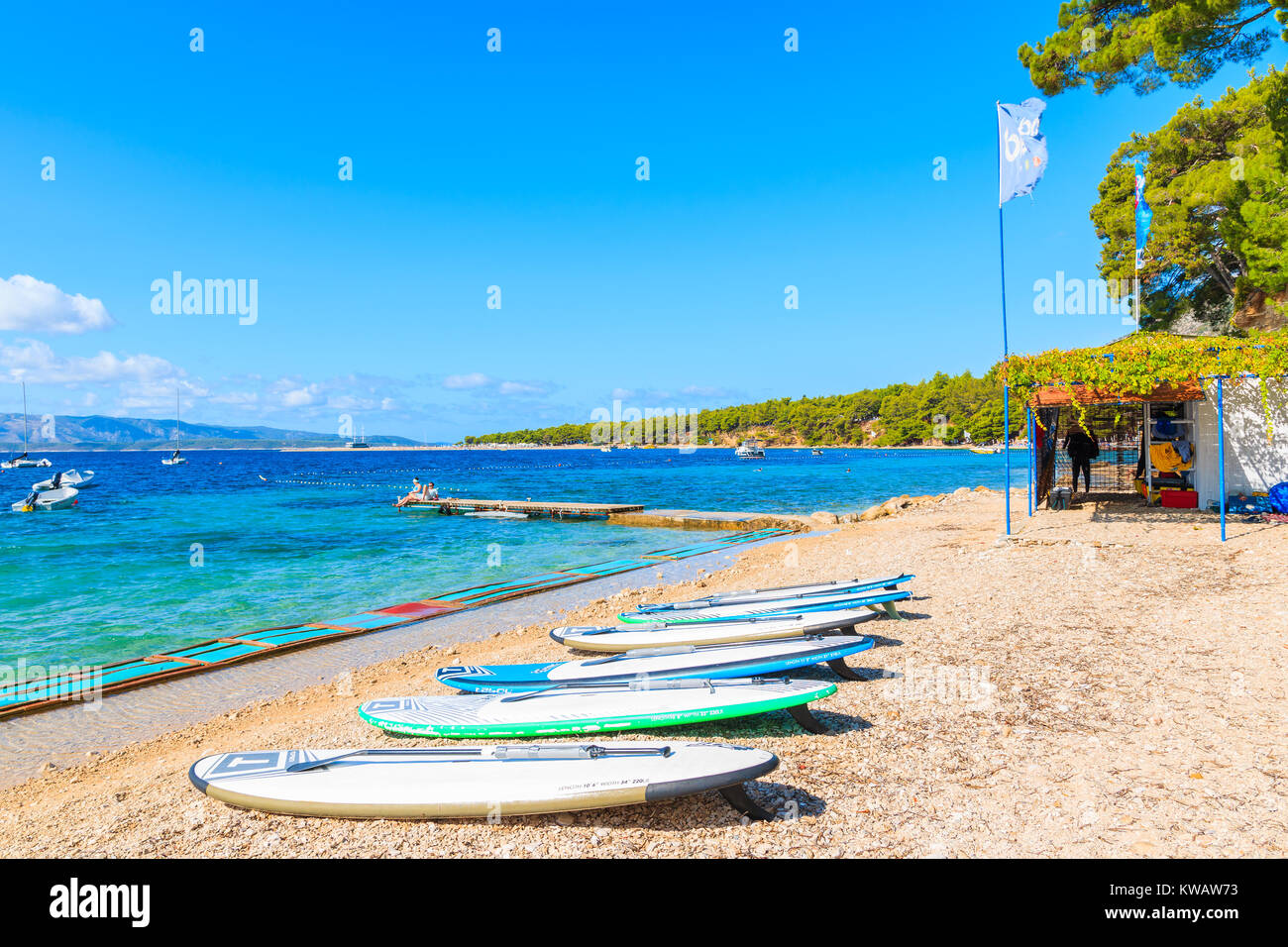 BOL BEACH, BRAC ISLAND - SEP 13, 2017: windsurfing boards laying on famous Zlatni Rat beach in Bol town, Brac island, Croatia. Stock Photo