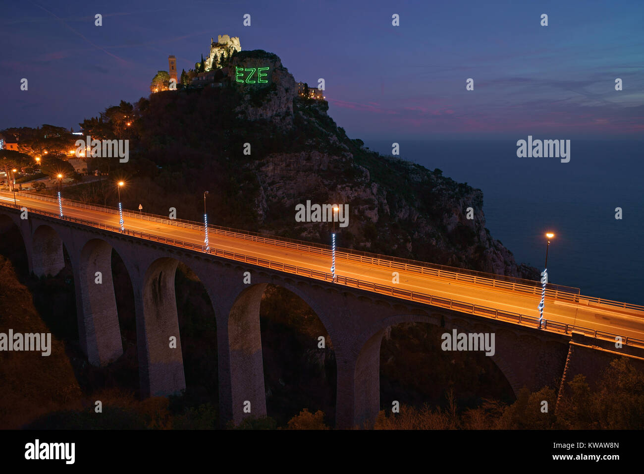 Time exposure of Èze-Village with its access bridge. Village's name displayed on the cliff with a laser projection. French Riviera, France. Stock Photo