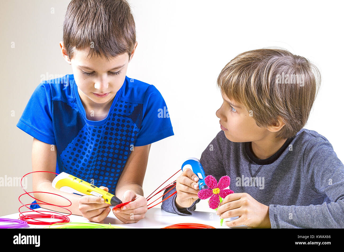 Happy children creating with 3d printing pen Stock Photo - Alamy