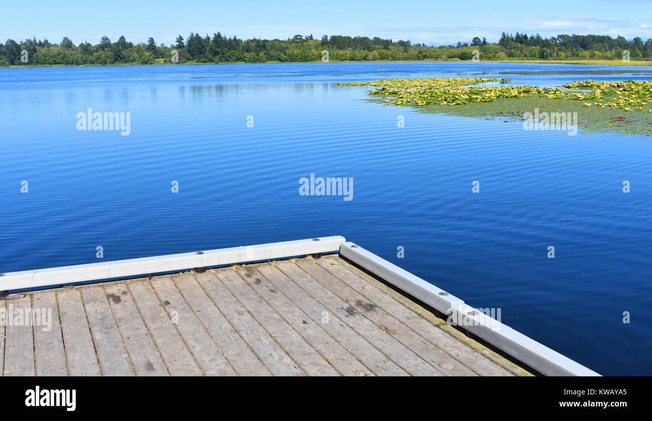 The man made Lake Terrell in Pacific Northwest city of Ferndale, Washington, USA.  The beautiful blue waters are home to waterfowl and various fish. Stock Photo