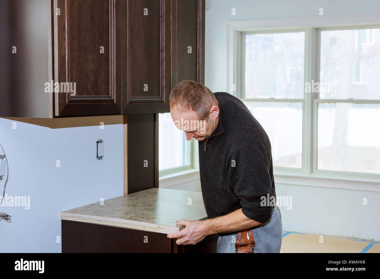 Installation of induction stove or cooktop by a master Stock Photo Alamy