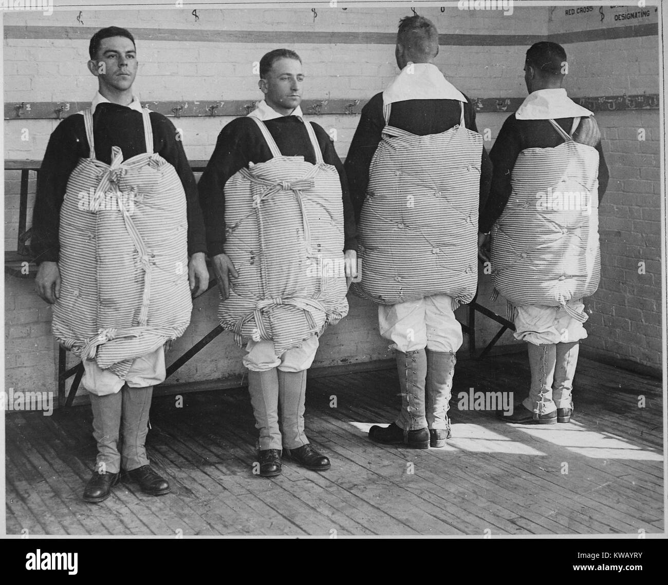 US naval recruits standing with mattresses tied to them to serve as life preservers, Newport Naval Training Station, Rhode Island, April, 1917. Image courtesy National Archives. Stock Photo