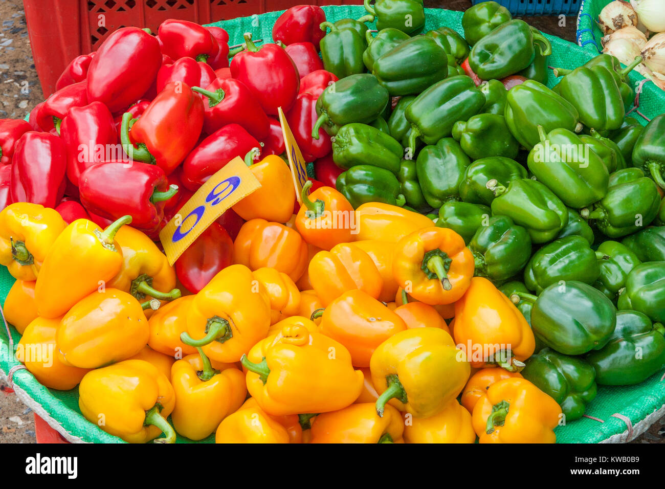 red,green and yellow peppers for sale on market stall, Bangkok ...