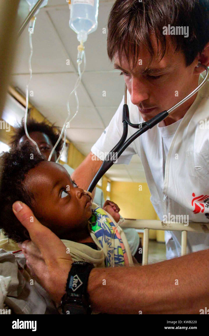 Medicin Sans Frontier doctor Simon Pulfrey treats Grace, 9 months, in the ward set aside for possible cholera victims at Goma's General hospital.    Jan 2002 Stock Photo