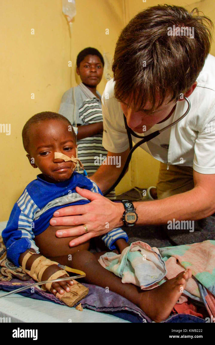 Mike Goldwater  / Network Photographers  Medicin Sans Frontier doctor Simon Pulfrey treats Olivier, 21 months old, in the ward set aside for possible cholera victims at Goma's General hospital.    Jan 2002 Stock Photo