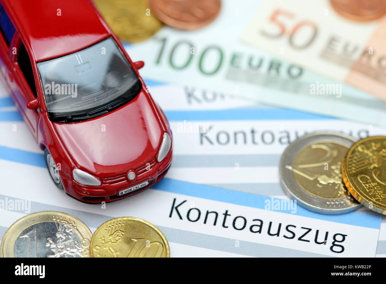 Miniature car on bank statements, symbolic photo vehicle assurance, Miniaturauto auf Kontoausz?gen, Symbolfoto Kfz-Versicherung, Miniaturauto auf Kont Stock Photo