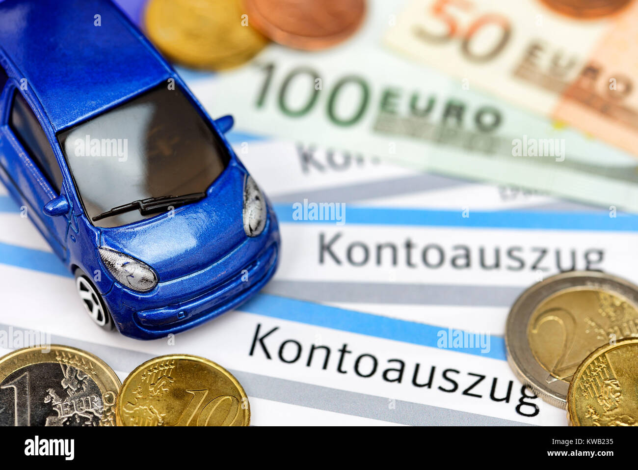 Miniature car on bank statements, symbolic photo vehicle assurance, Miniaturauto auf Kontoausz?gen, Symbolfoto Kfz-Versicherung, Miniaturauto auf Kont Stock Photo