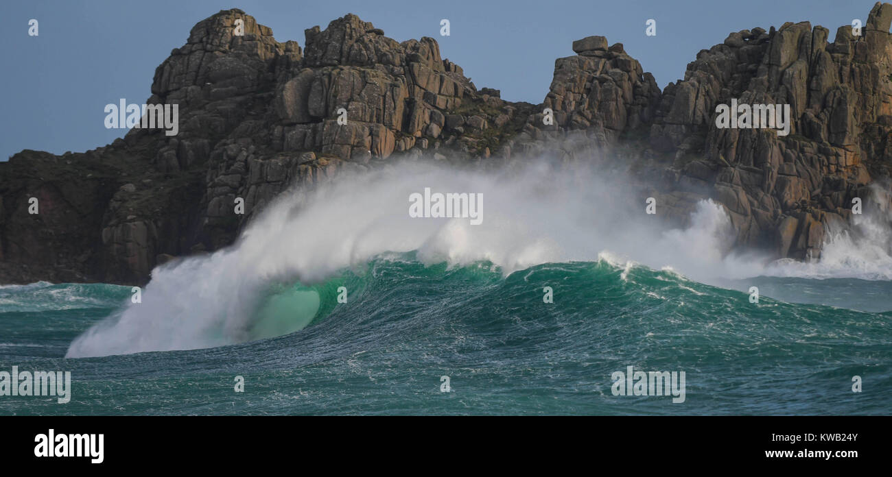 Stormy waves of winter down at the beach in Porthcurno, Cornwall just as Storm Elenor was picking up speed and force.  Shows the force of nature. Stock Photo