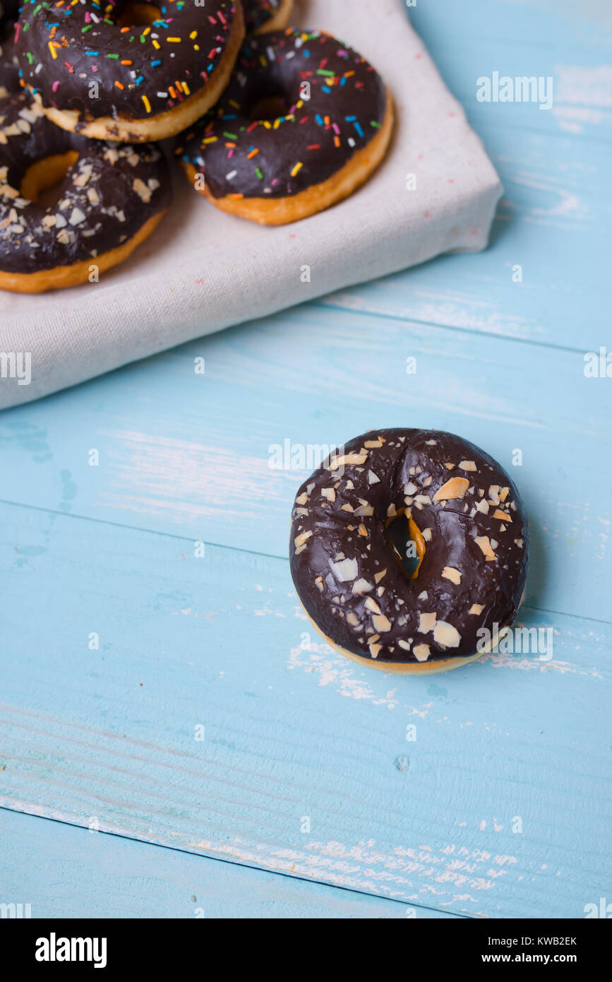 Chocolate glazed donuts on wooden background with blank space Stock ...