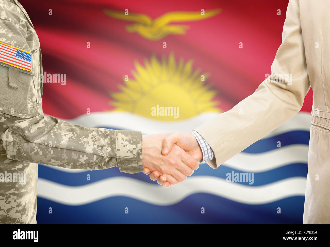 American soldier in uniform and civil man in suit shaking hands with adequate national flag on background - Kiribati Stock Photo