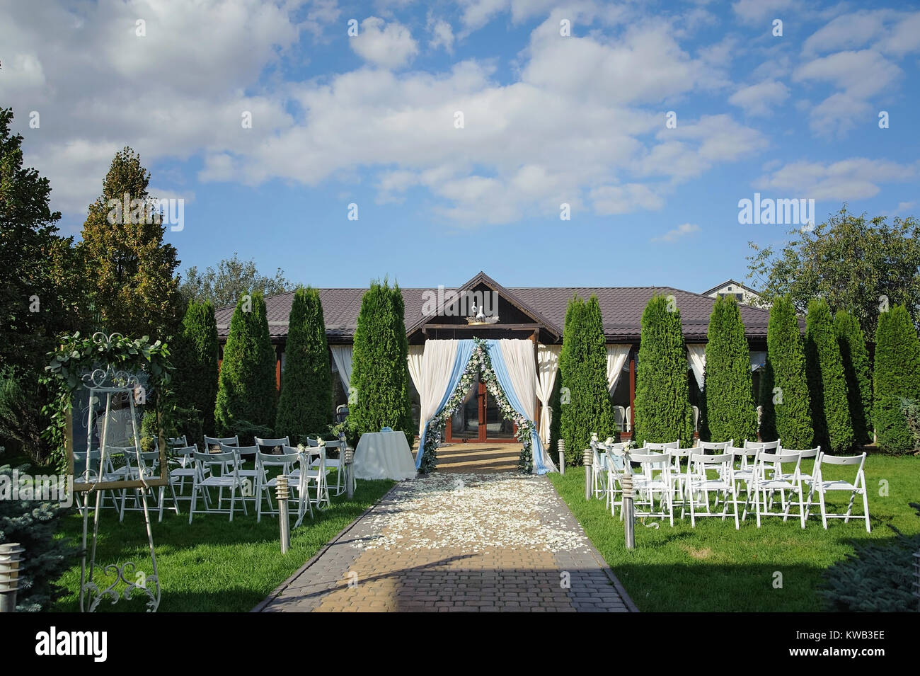 The wedding ceremony in the garden with an arch of green lawn  Rustic Stock Photo