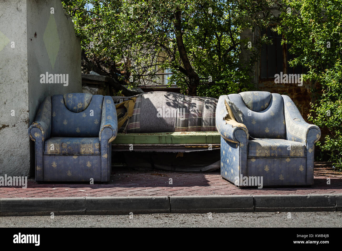 Old worn furniture left in front of an old house wall Stock Photo Alamy