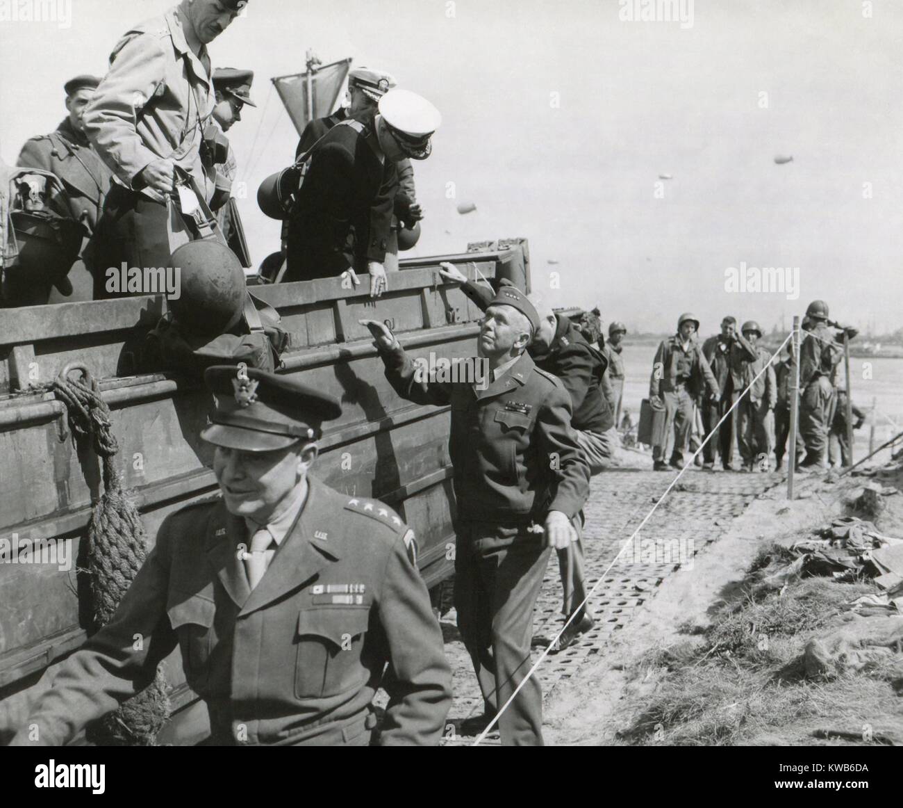 U.S. Chiefs make inspection in France a week after the D-Day invasion in Normandy. June 14, 1944. Walking beside vehicle: Eisenhower, Supreme Allied Commander; General George Marshall, Chief of Staff; and (obscured behind Marshall) Henry Arnold, Commanding General, Army Air Force. World War 2. (BSLOC 2014 8 114) Stock Photo