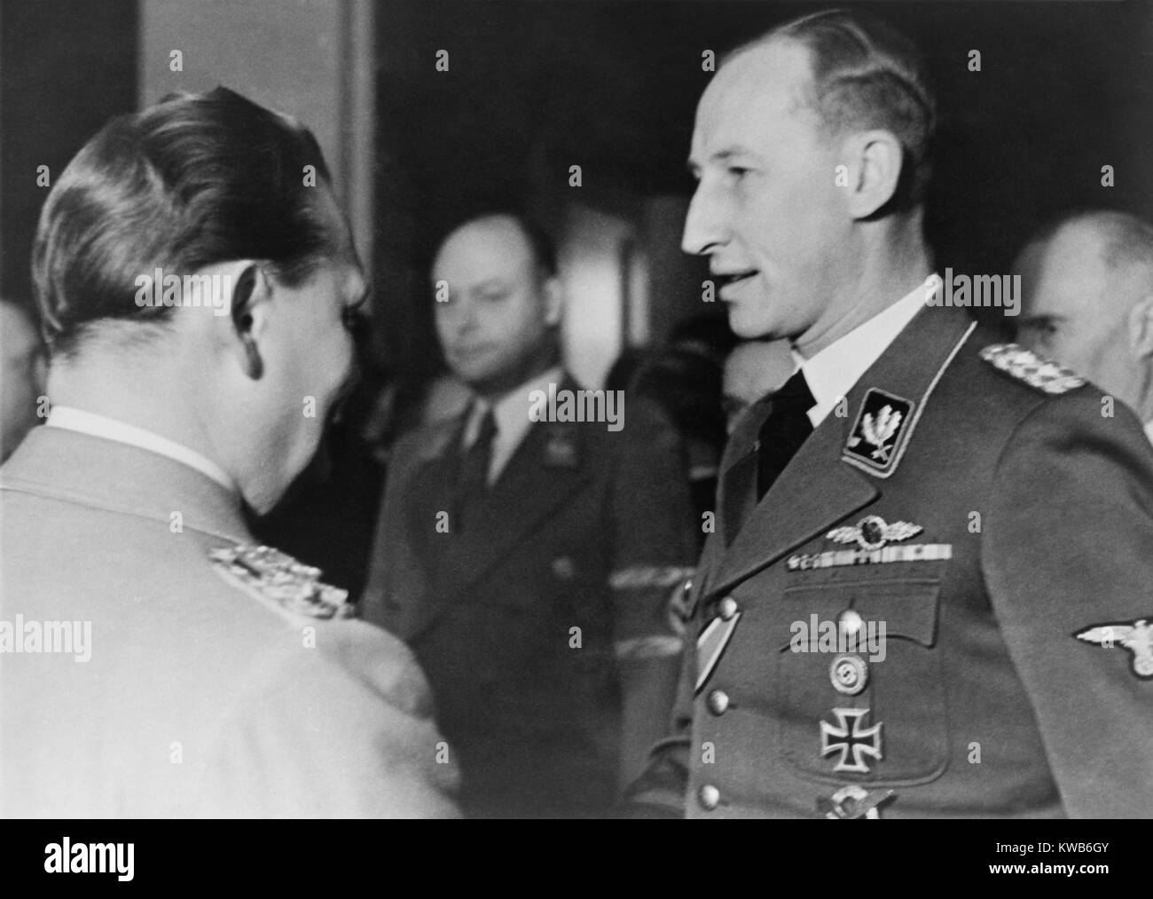 Reinhard Heydrich speaking with Hermann Goering at Goering's birthday celebration, Jan. 12, 1942. In this same month, January 1942, Heydrich chaired the Wannsee Conference, which planned the 'final solution' for the deportation and extermination of all Jews in German-occupied territory during World War 2. (BSLOC 2014 8 155) Stock Photo