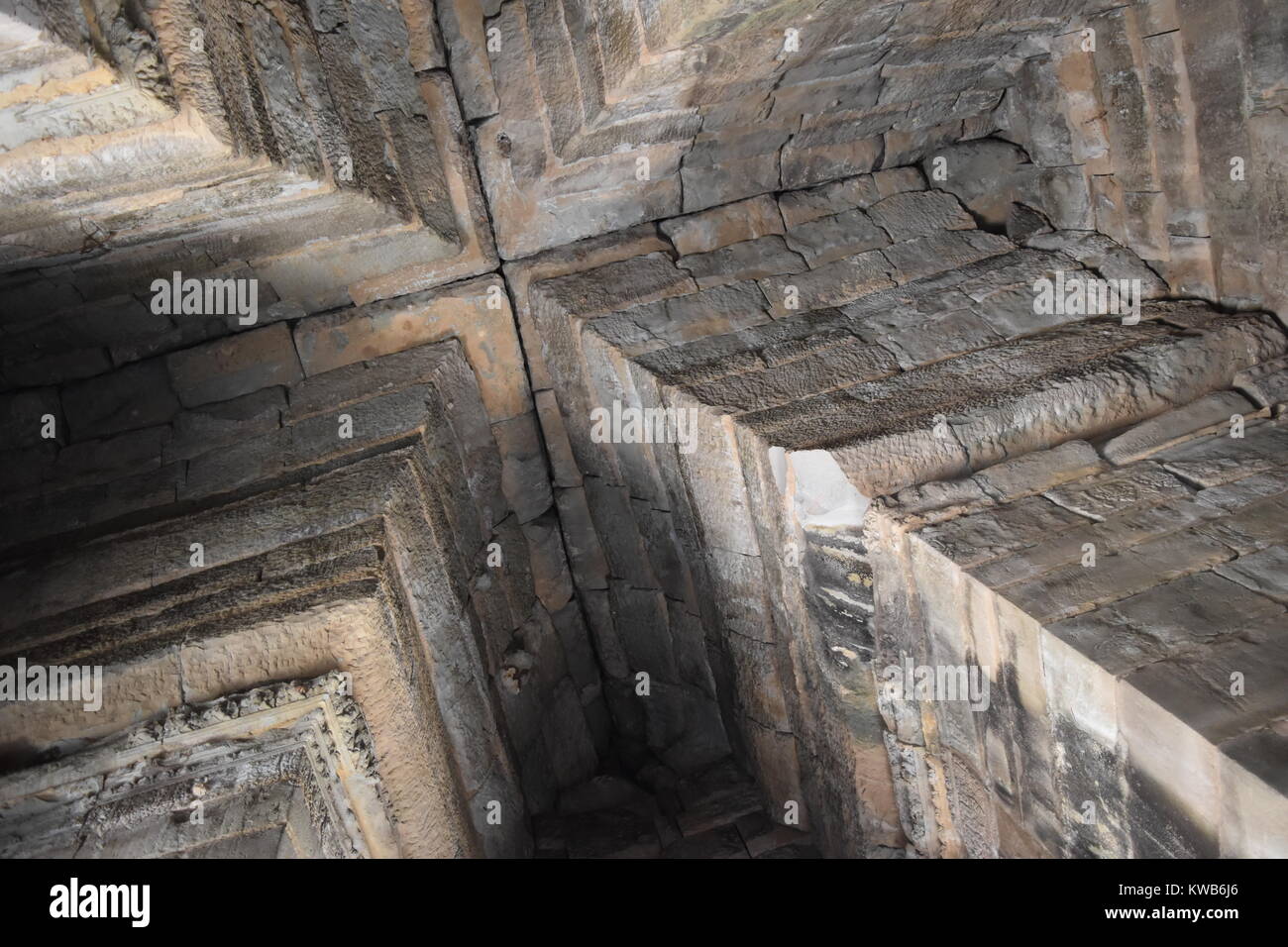 Cross shape ceiling formed by arch columns inside the ancient Angkor Wat stone temple in Cambodia Stock Photo