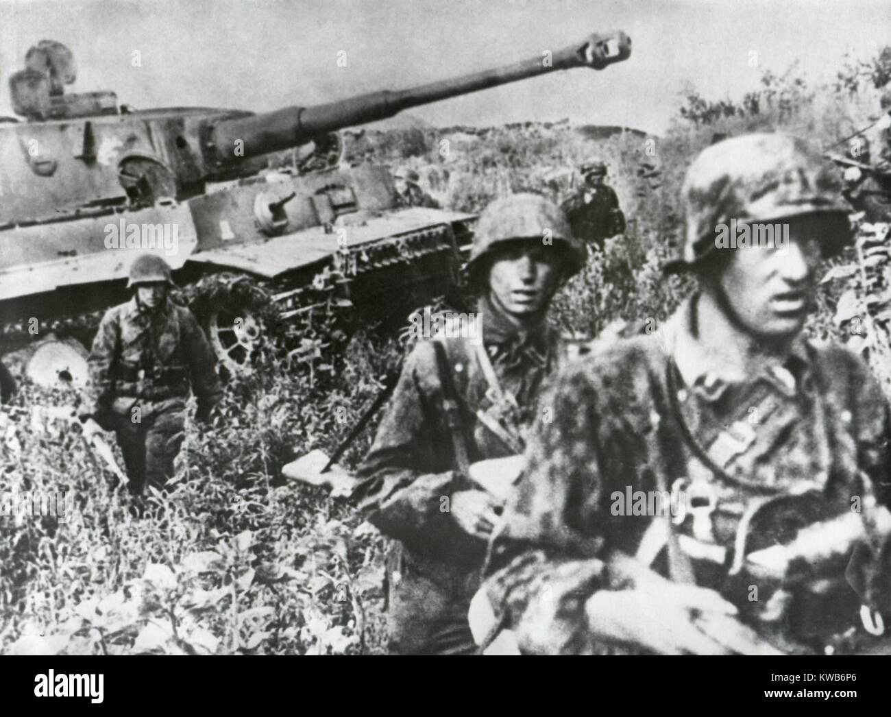 German Infantry in camouflaged clothing retreating with a tank on the Kuban Front. German troops held the Kuban position after retreating from the Caspian oil fields, retreated further to the Crimean peninsula in Oct. 1942. World War 2. (BSLOC 2014 8 22) Stock Photo