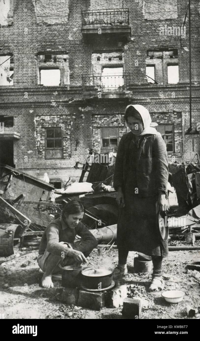 Soviet (Russian) civilians cooking in the ruins of Stalingrad. The 'Hero City' was in ruins in Nov. 1944, over 18 months after the defeat of the Germans in Feb. 1943. World War 2. (BSLOC_2014_8_42) Stock Photo