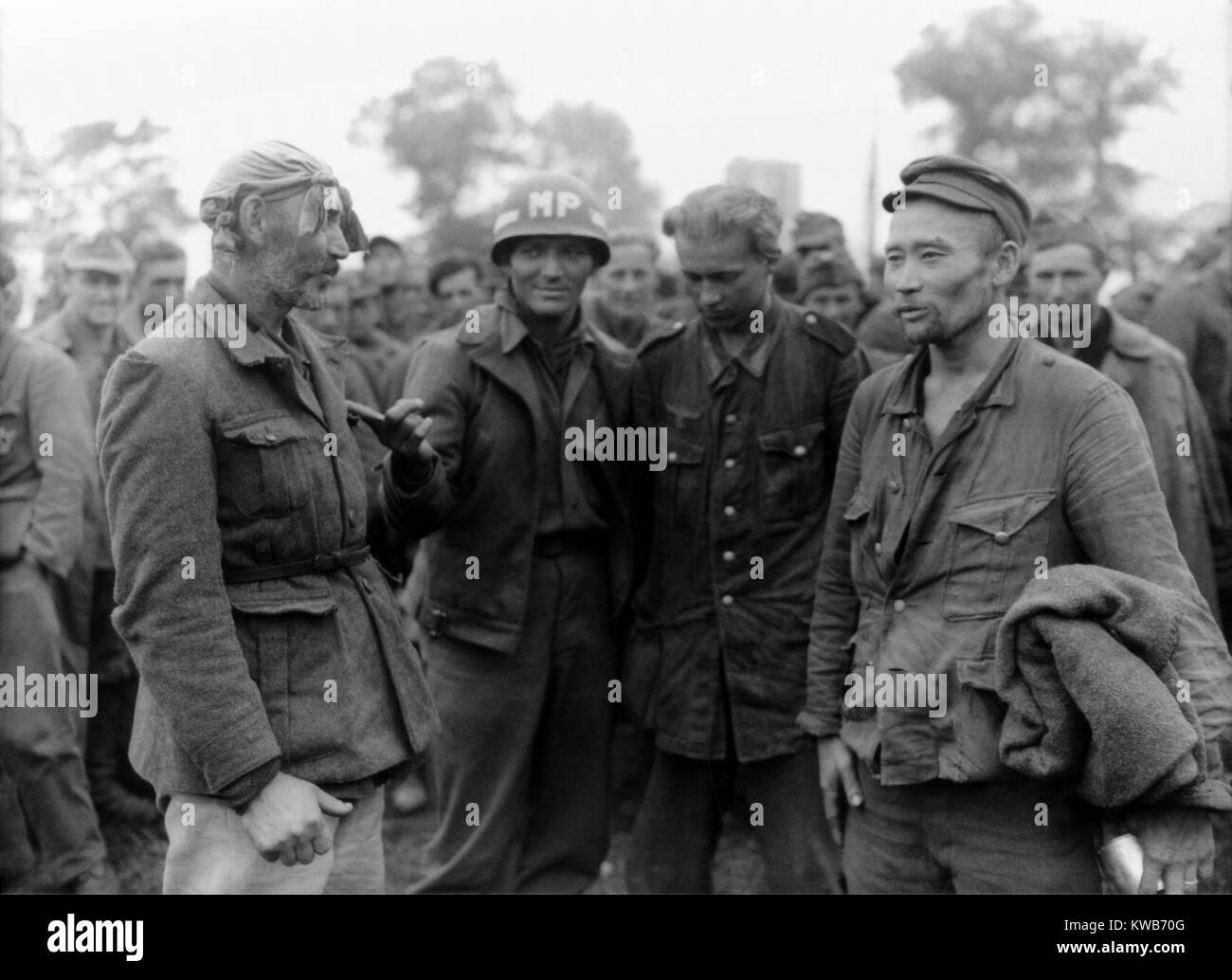 Two older POWs fighting in the German army were White Russian Mongols. At the end of the war they would be forcibly repatriated to an unpromising future in the Soviet Union (Russia). August, 11, 1944, near Nonat le Pin, France. World War 2. (BSLOC 2014 8 91) Stock Photo