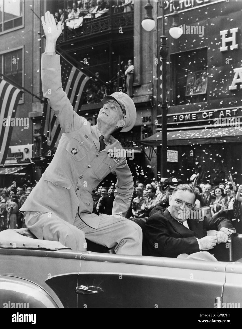 General Jonathan Wainwright, waving to crowd during ticker tape parade, New York City. As the highest-ranking U.S. POW, he survived three years in Japanese camps until his liberation by Soviet (Russian) troops in August 1945. NYC Mayor Fiorella LaGuardia shares the car on Sept. 14, 1945. (BSLOC 2014 8 135) Stock Photo