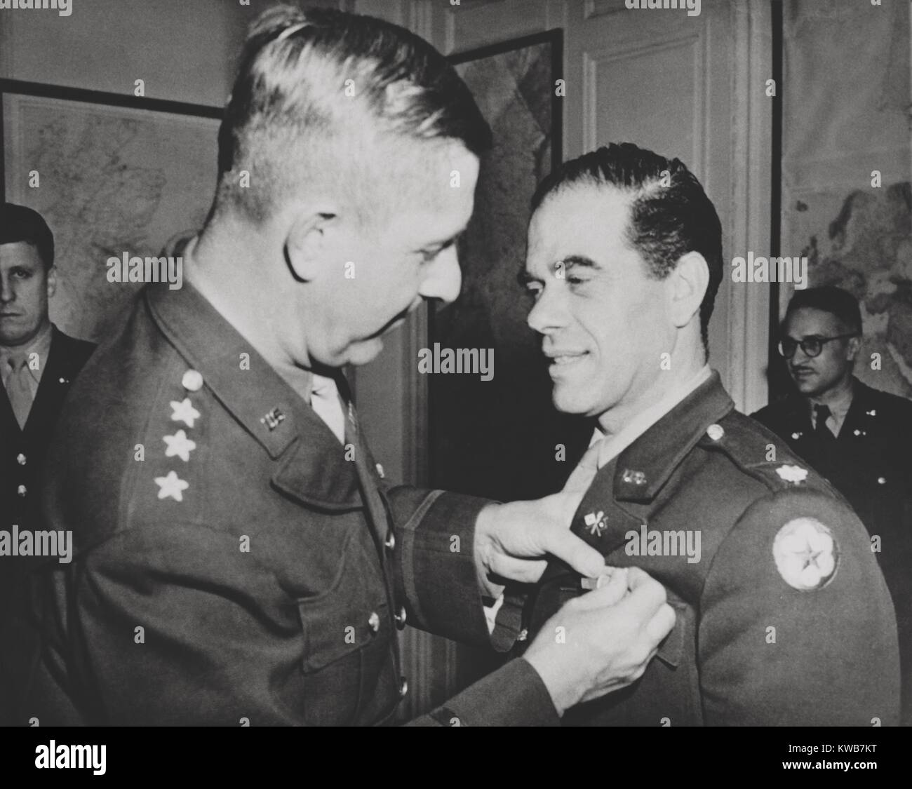 Lt. Col. Frank Capra, receives the Legion of Merit. The Hollywood movie director was chief of the U.S. Army Signal Corps motion picture production unit. He produced, 'Why We Fight', a series of pictures on events leading up to our entry into war, for use in Army orientation courses. Nov. 29, 1943. World War 2. (BSLOC 2014 10 238) Stock Photo