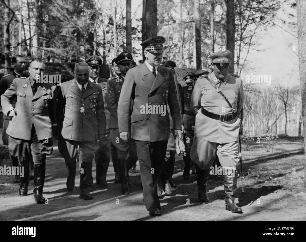 Adolf Hitler and Hermann Goering walking in a group. L-R: Martin Bormann, Robert Ley and Heinrich Himmler. They were at Hitler's headquarters on his birthday. April 20, 1942, during World War 2. (BSLOC_2014_8_172) Stock Photo