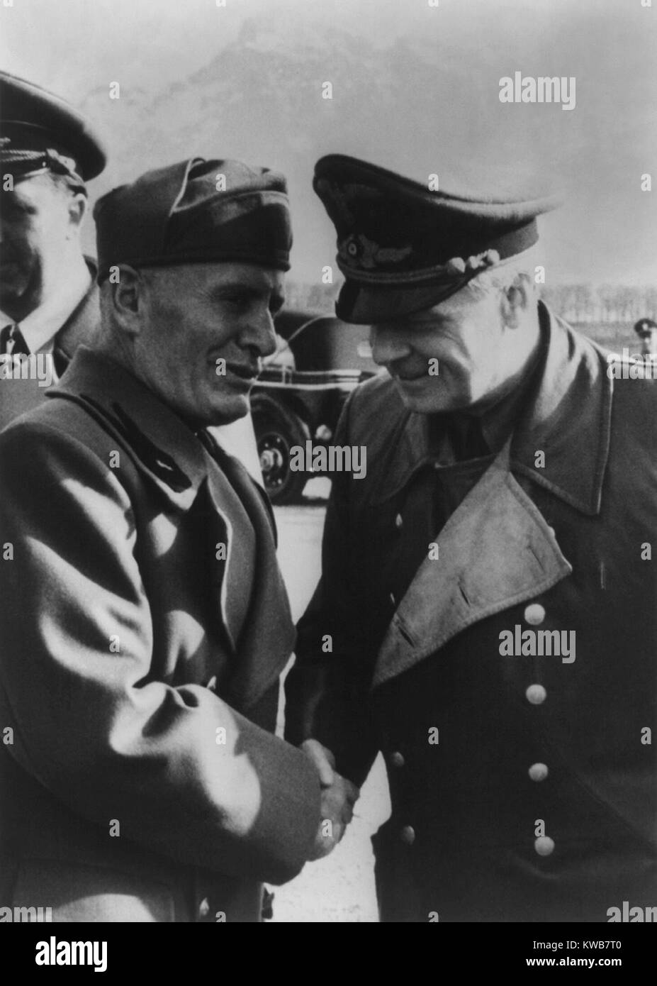 Mussolini greeting Joachim von Ribbentrop, with the German ambassador to Italy, Rudolf Rahn. April 25, 1944. 10 months earlier, Mussolini was ousted and replaced by Marshal Pietro Badoglio who dissolved Fascist party. The Nazis continued to prop up the powerless dictator for another year. World War 2. (BSLOC 2014 8 174) Stock Photo