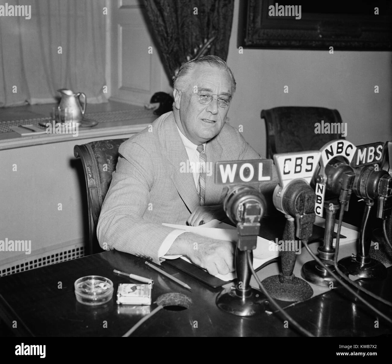 President Roosevelt broadcasting a 'Fireside Chat' on May 26, 1940. He spoke of the World situation as Nazi armies advanced through Western Europe and of U.S. defense plans. He attacked isolationists, as 'the Trojan Horse and the Fifth Column that betrays a nation unprepared for treachery'. World War 2. (BSLOC 2014 8 186) Stock Photo