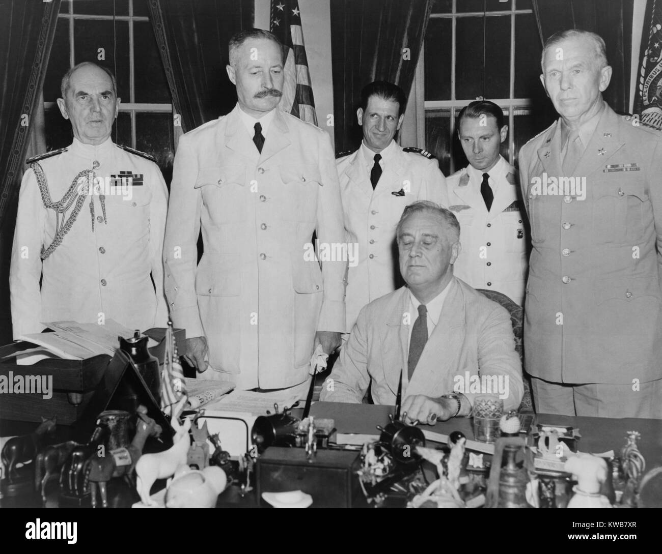 President Roosevelt hosts French General Henri Giraud, of French forces in Africa, July 1943. Giraud and Charles DeGaulle were rivals for French wartime leadership, with Giraud favored by the U.S. in 1943. Soon, his poor political skills reduced his influence. Standing behind FDR: Adm. William Leahy (far left); Gen. Henri Giraud (left); Gen. George Marshall (far right); in back are two of Giraud's aides. World War 2. (BSLOC 2014 8 190) Stock Photo