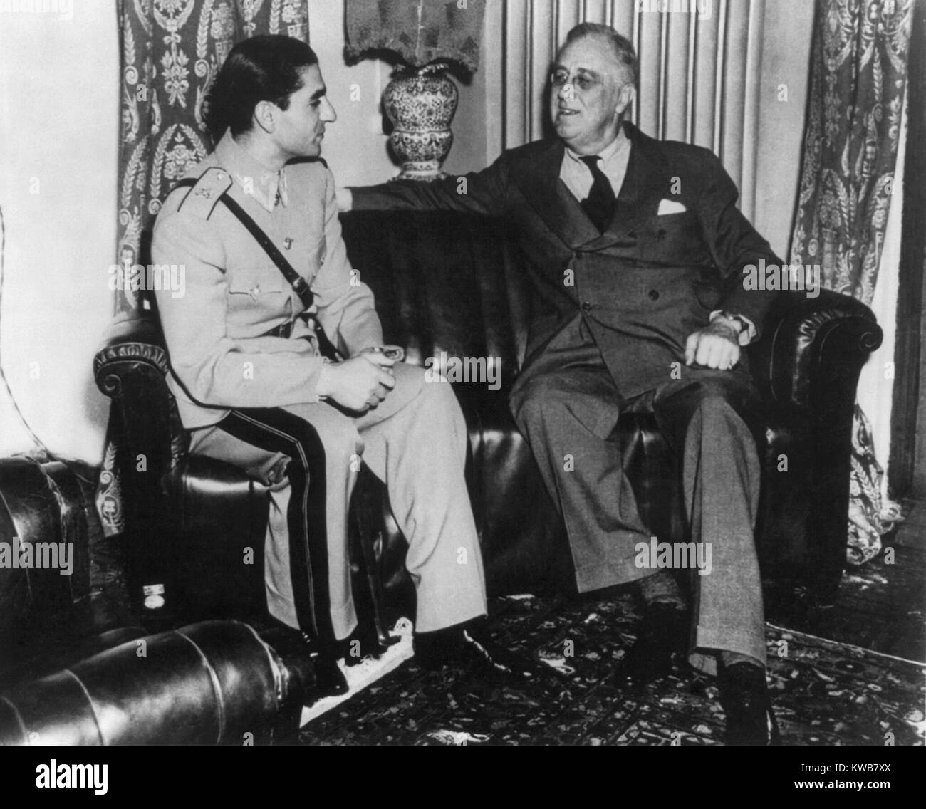 Reza Pahlevi, Shah of Iran, with President Roosevelt during the Teheran Conference. Nov. 28-Dec. 1, 1943. Mohammad Reza Pahlavi, then 24, came to limited power after an Anglo-Soviet invasion of Iran forced the abdication of his father, Axis leaning Reza Shah. World War 2. (BSLOC 2014 8 191) Stock Photo