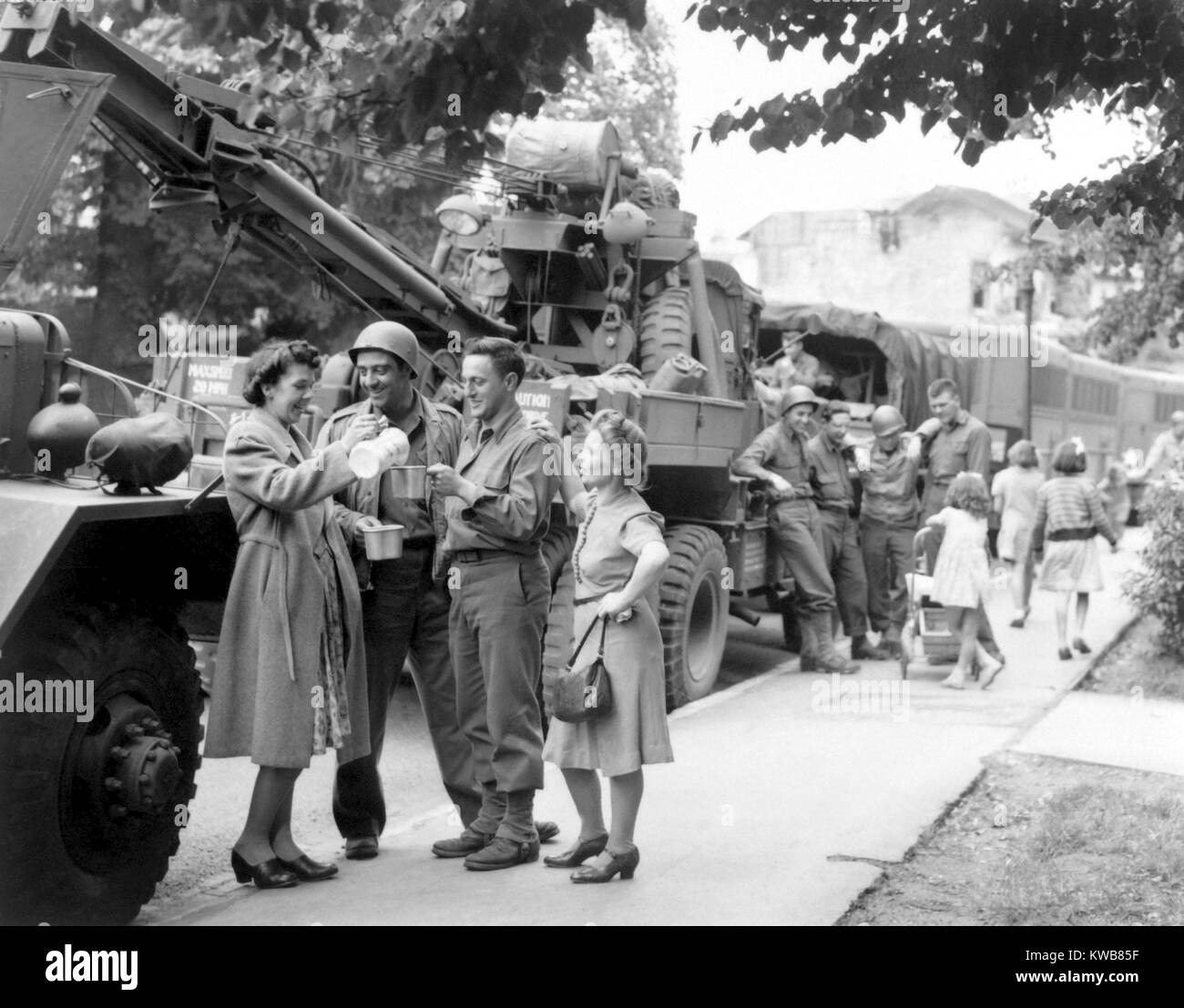 English townsfolk serve hot coffee to U.S. Army Ordnance men. They are awaiting their 'go' signal to join the ongoing invasion of France. July 24, 1944. World War 2. (BSLOC 2014 10 64) Stock Photo