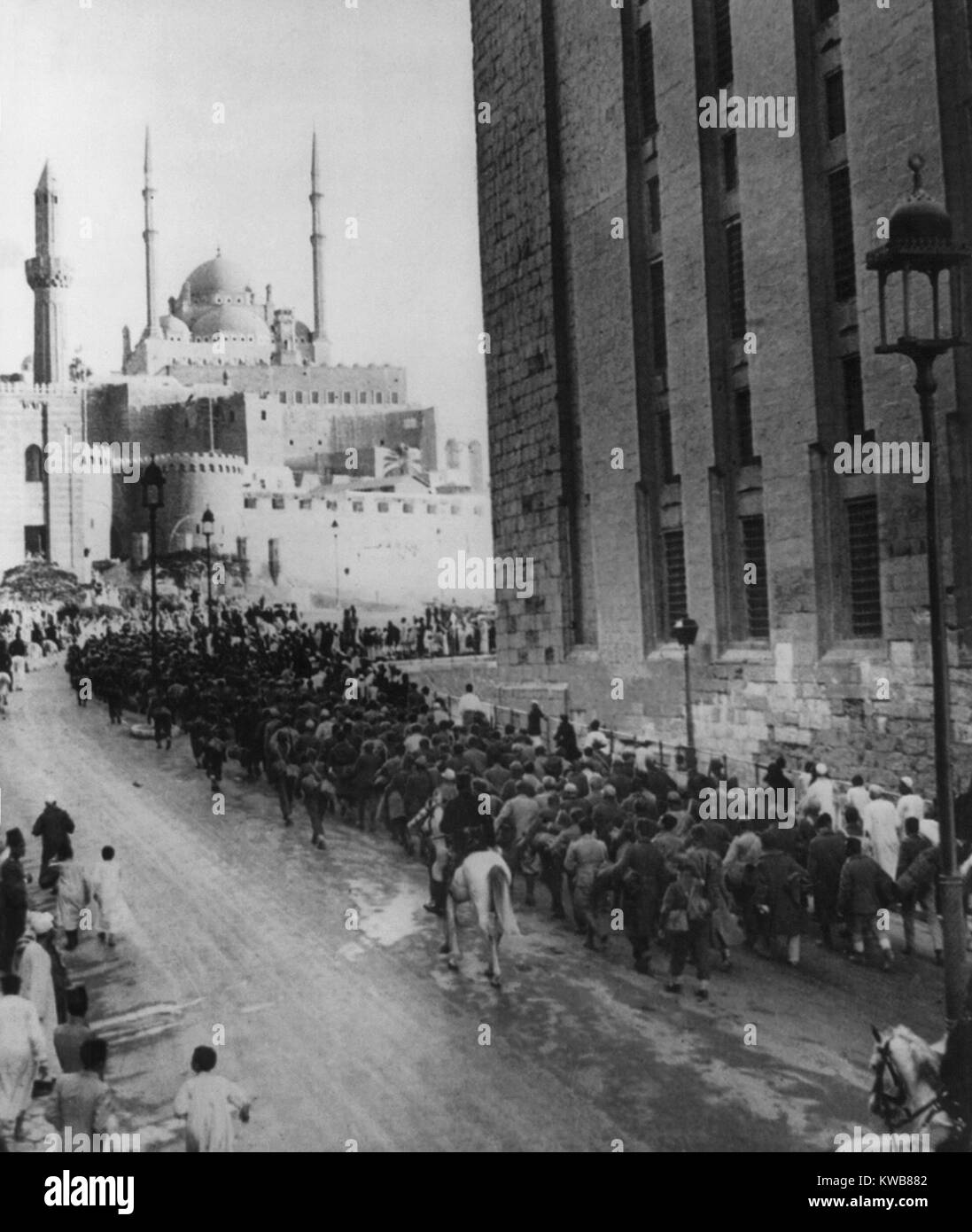 Axis prisoners captured in Libya nearing the Citadel of Cairo. Italian and German POWs march within view of the Mohamed Ali Mosque above and the Mosque of Sultan Hassan. Ca. 1942 during World War 2. (BSLOC 2014 10 8) Stock Photo