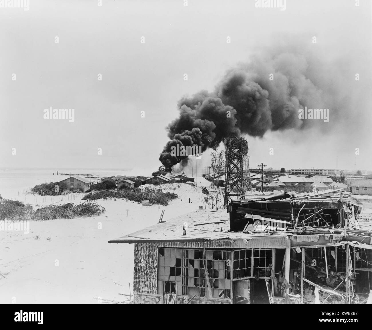 Smoke rising from burning oil tanks on Sand Island, Midway, after Japanese air attack, June 4, 1942. This marked the beginning to the two day Battle of Midway, which resulted in a decisive U.S. victory and the withdrawal of Japanese forces. World War 2. (BSLOC 2014 10 97) Stock Photo