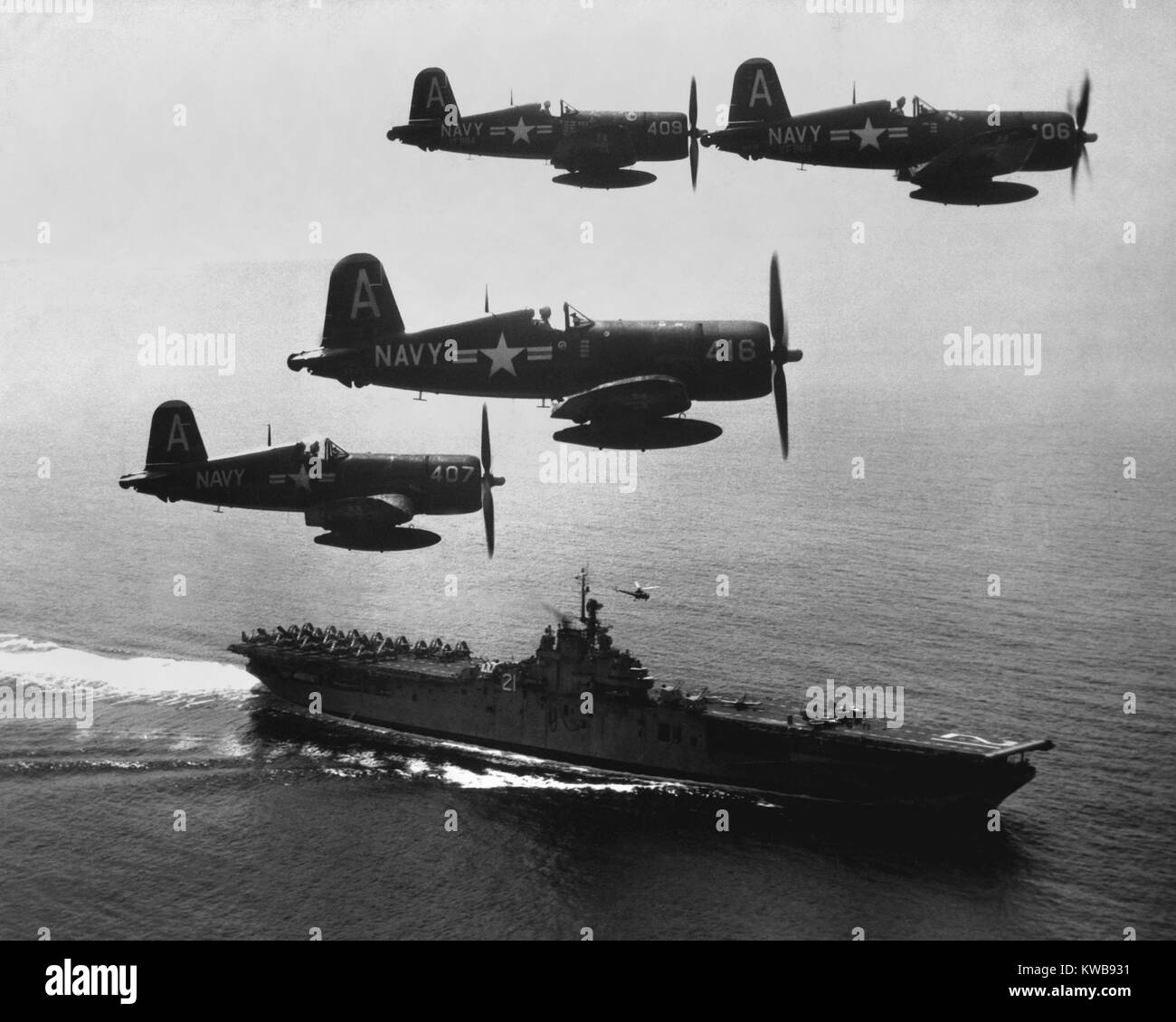 F4U's (Corsairs) returning from a combat mission over North Korea to the USS Boxer. Planes in the next strike are about to be launched from the carrier flight deck. Sept. 4, 1951. Korean War. (BSLOC 2014 11 224) Stock Photo