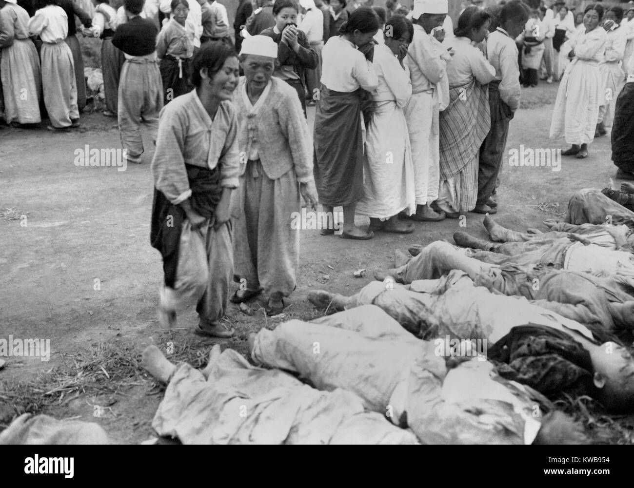 Koreans from Hamhung identify bodies of political prisoners killed by the North Korean Army. Some 300 were forced into caves which were subsequently sealed, so that they died of suffocation. October 19, 1950. Korean War, 1950-53. (BSLOC 2014 11 239) Stock Photo