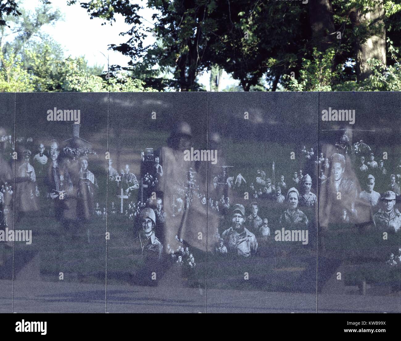 Korean War Veterans Memorial, Washington, D.C. One element of the memorial is a polished granite wall with photographic images representing the land, sea and air troops who supported those who fought in the war on land. Sculptures of 'soldiers on patrol' are reflected in the wall. It was dedicated on July 27, 1995. (BSLOC 2014 11 277) Stock Photo