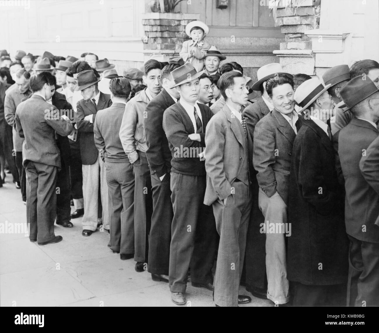 San Franciscans of Japanese ancestry, appearing at the Civil Control Station for registration. In accordance with the Army's exclusion order No. 20, Japanese Americans would be interned in remote concentration camps for the duration of World War 2. (BSLOC 2014 10 249) Stock Photo