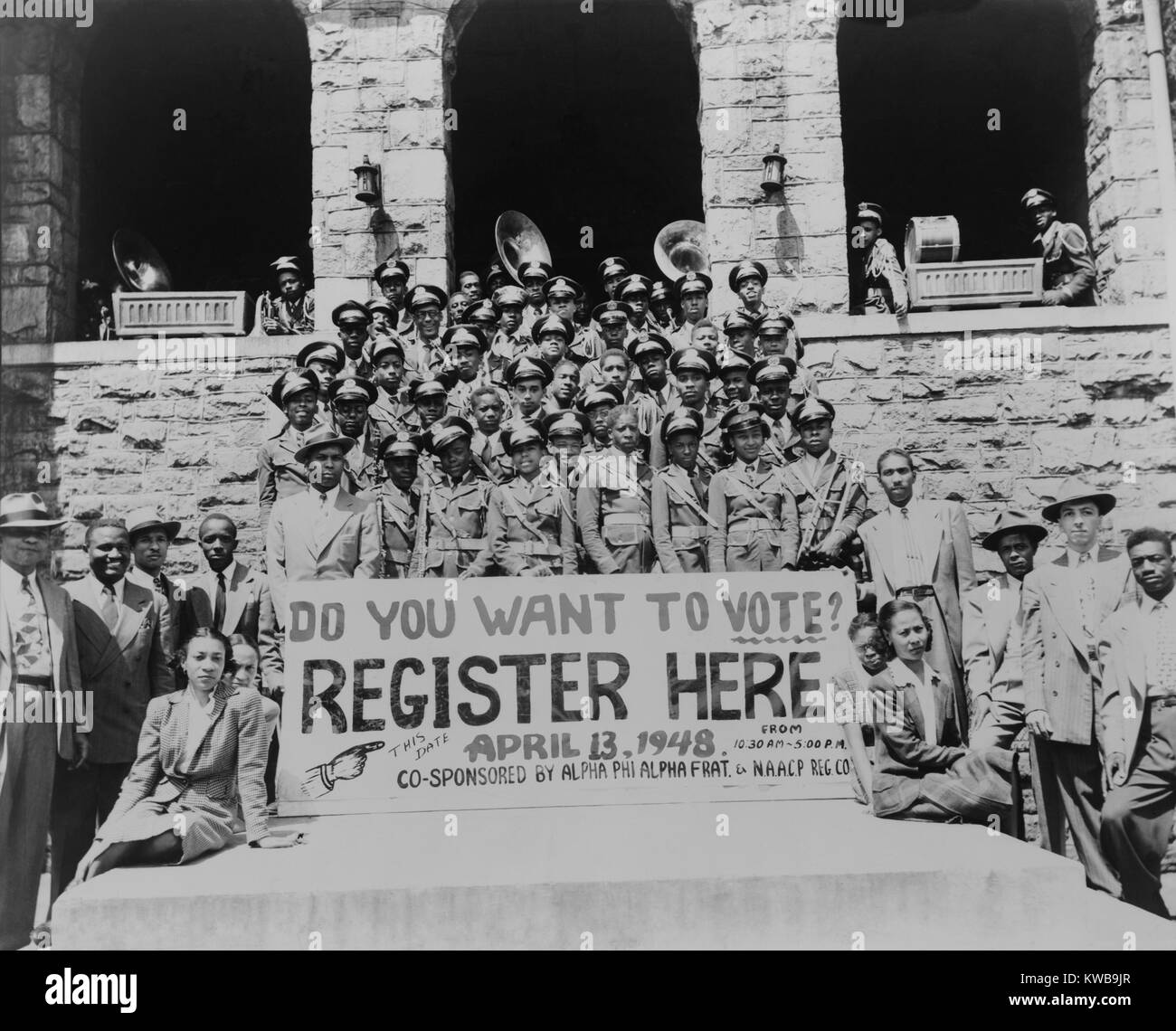 African Americans encouraging voter registration at an unidentified college campus in 1948. They hold a large banner reading, 'Do you want to vote?--Register here April 13, 1948'. (BSLOC 2014 13 118) Stock Photo