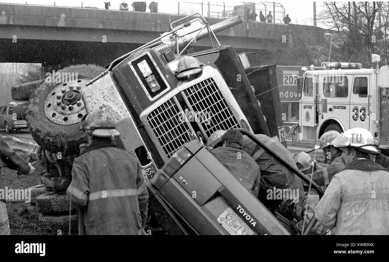 Firefighters struggle to get the occupant of a pickup truck out after a ...