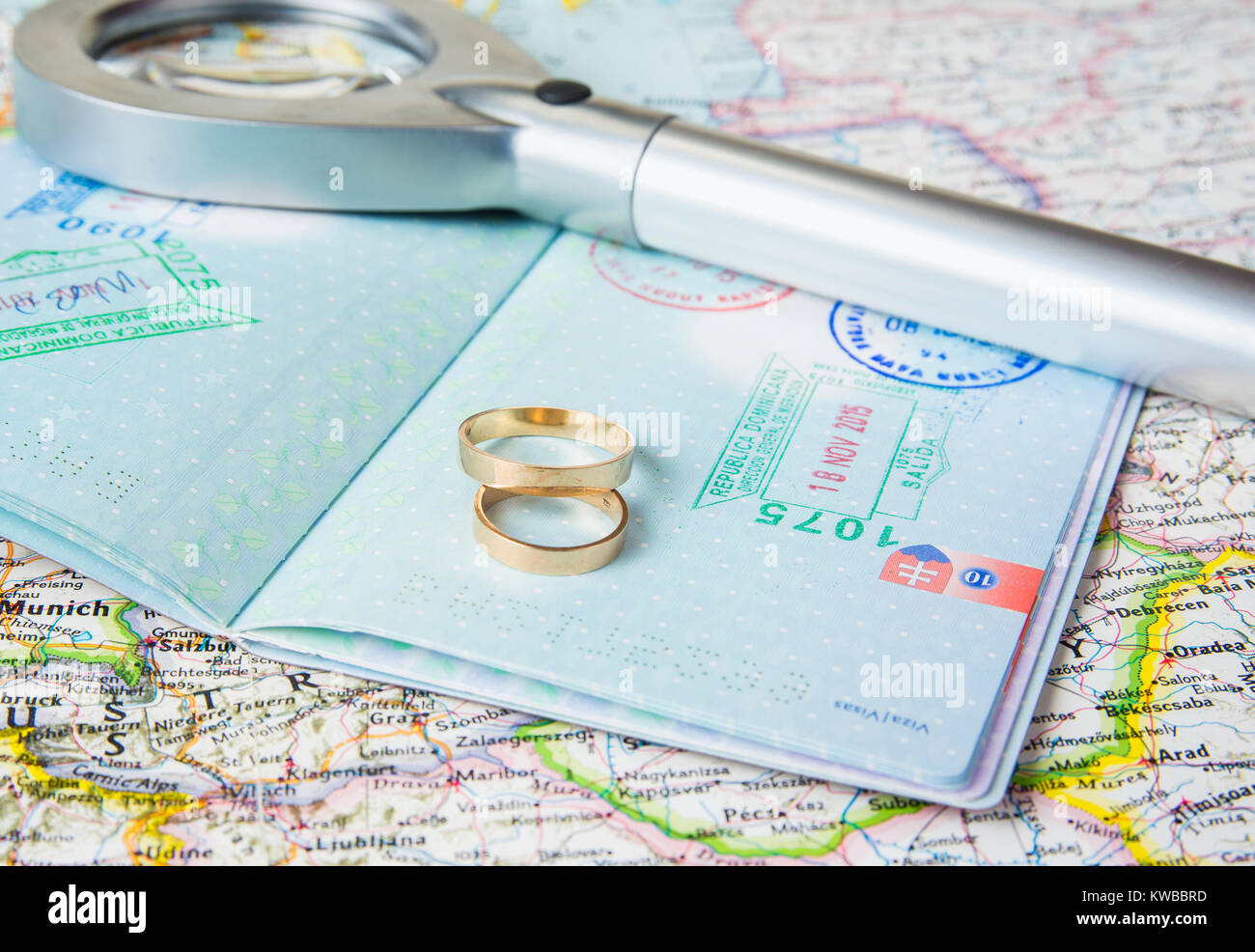 Honeymoon concept. Wedding rings with passports on the map. Stock Photo