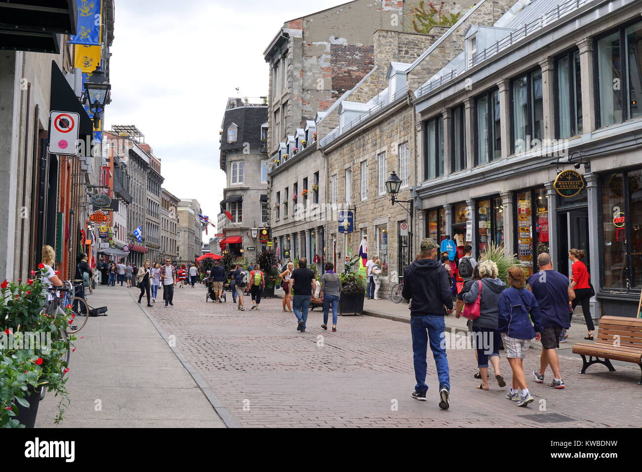 Travelers walking on Rue Saint Paul Est, a cobblestone street with small shops in Old Montreal, Quebec, Canada Stock Photo